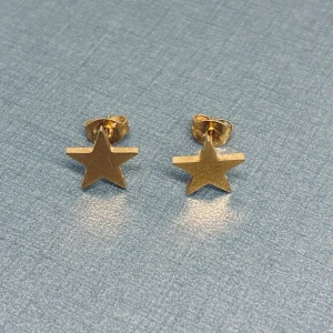 Guldiga stjärnformade örhängen - Snygga örhängen i form av stjärnor i guldig färg. Perfekta för dig som vill ha en cool och unik detalj till din look. Stiftmodell som sitter bekvämt på örat och ger en trendig vibe.