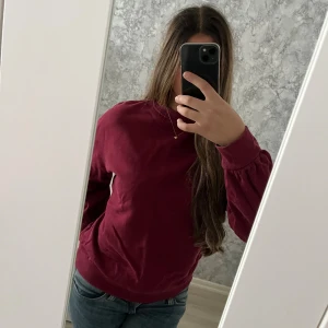 Vinröd sweatshirt från Urban Classics - Enkel och snygg vinröd sweatshirt från Urban Classics i storlek M. Tröjan har rund halsringning, ribbade muddar och är tillverkad i mjuk bomull. Perfekt för chill dagar eller när du vill ha en clean look. Vid frågor hör av dig!