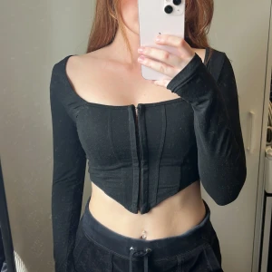 Svart långärmad korsett-topp - Storlek XS
