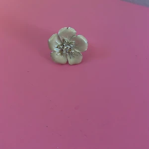Fin silverring med blomma - Trendig ring i Silver som är använd fåtal ggr. Diamanterna är ej äkta! Perfekt för vardag🥰 Storleken kan göras större och mindre på baksidan (bild 3). Men just nu är den 18,1 mm