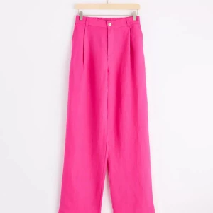 Rosa linnebyxor | Lindex, strl 34 - Rosa linnebyxor från Lindex i storlek 34. Byxorna har raka ben, fickor fram och bak samt hällor för bälte. Perfekta för en färgstark look och sköna tack vare det tunna linnematerialet! 🩷(lite ostrukna, men de är rena från tvätt :) 