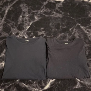 Blåa basic t-shirts från 157 - Blåa svarta basic t-shirts från 157 med rund halsringning. Perfekt passform och tillverkade i mjuk bomull som känns skön mot huden. Enkla att matcha med allt och ett måste i garderoben för en clean och stilren look. Ena är i str 150 och den andra 160