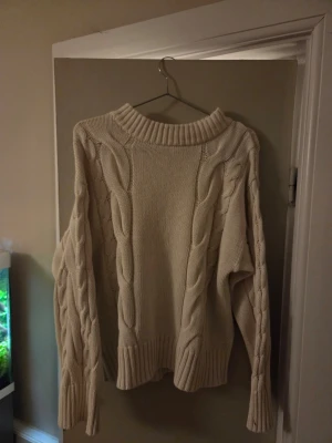 Kabel stickad tröja  - Säljer en vit snygg stickad kabeltröja. Tröjan är i storlek M men jag skulle säga att den är mindre i storleken, så den passar nog någon som har storlek S väldigt bra.