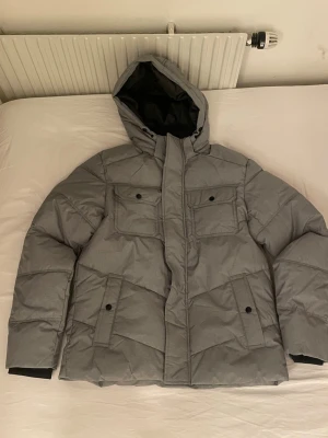 Grå pufferjacka från Jack & Jones - Skön grå puff jacka perfekt nu i vintern, den är helt oanvänd, storlek S. Ny pris 899kr. Pris kan diskuteras, kom dm för mer frågor!
