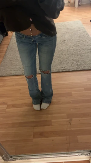 Blå bootcut jeans - Säljer dessa jeans från Nelly eftersom jag inte använder dem längre, as fina på, inget fel på jeansen förutom att de är lite slitningar längst ner men de abslout inget som är ett problem.