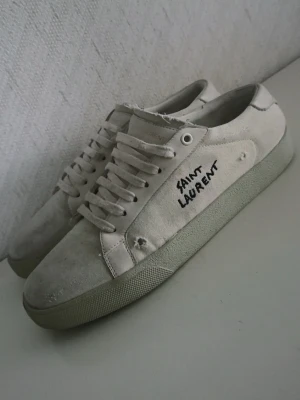 Saint Laurent sneakers  - Tja! Säljer dessa feta skor från YSL. Slitningarna på skorna är skornas designe därav att de ser slitna ut. En snabb rengöring på skorna skulle inte skada, men annars väldigt fina 🤩Skriv gärna ifall du har några frågor! ✌️( Obs ingen box eller annat tillkommer, endast skorna! ) 