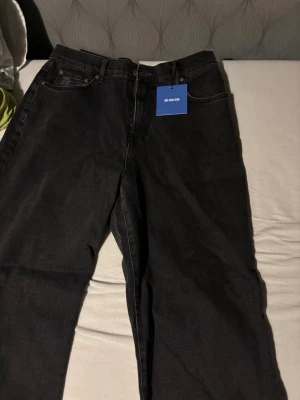 Svarta jeans från Que Sera Sera - Säljer ett par svarta jeans från Que Sera Sera i klassisk rak modell. Jeansen har fem fickor, bälteshällor och stängs med dragkedja och knapp. Perfekta till alla typer av outfits och riktigt sköna att bära. Helt oanvända, då jag fick dem i födelsedagspresent och de passade ej.nypris 700