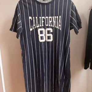 Randig t-shirtklänning från HM Divided - Blå vitrandig t-shirtklänning från HM Divided i storlek 34. Väl använd, något urtvättad men annars hel.