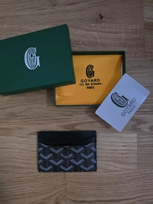 Svart Gy plånbok/kortbehållare - Svart plånbok/cardholder från Gy. Helt ny och för ett billigt pris. Box och allt som syns på första bilden följer med. 