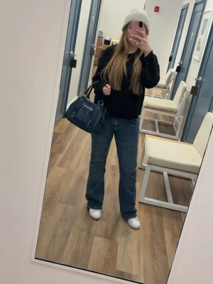 Blå bootcut jeans  - Snygga blå bootcut jeans med klassisk femficksdesign och normal passform. Jeansen har en lätt utsvängd benform och är tillverkade i mjukt denimtyg. Perfekta för en avslappnad och trendig look. Lite slitna längst ner, se bild och mamma har lagt dem vid skärpremmen men inget som jag kan se.