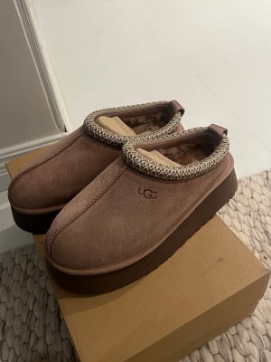 Tazz Slippers UGG Rocky Oak  - Uggs Tazz II slippers i färgen Rocky Oak, storlek 38. Köpta från Miinto, äkta. Aldrig använda och låda ingår. Säljes då de inte hann returneras i tid. 