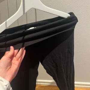 Yoga pants - Svarta leggings med bred, låg midja och stretchigt material. Perfekta för en chill och bekväm stil, sitter tight hela vägen ner och passar till allt. Mjuka och smidiga, enkla att matcha med oversized hoodie eller crop top.