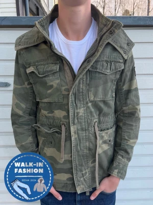 Abercrombie & Fitch jacka - Säljer en grön camouflage jacka från abercrombie & fitch som är sjukt vintage. Skick 7.5/10 då zippen inte funkar men fungerar utmärkt att använda knapparna!, går dessutom att laga billigt! Modellen är 186 men passar allt mellan 178-188 som bäst! Storlek S men passar M bättre. Hör av er vid funderingar. 