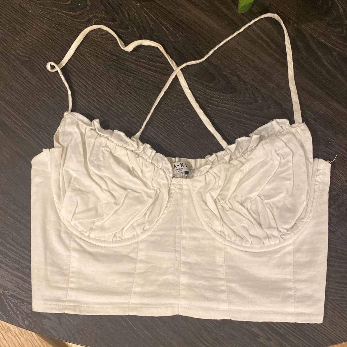 Vit linnetopp från NA-KD med kupdetalj