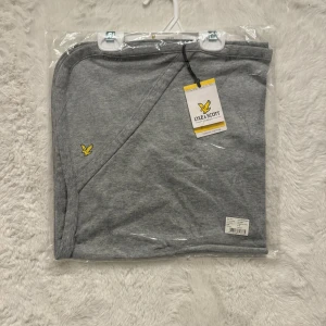 Lyle & Scott babyfilt 0–3 mån - Mjuk och fin babyfilt från Lyle & Scott Junior. I färg Vintage Grey Heather. Tillverkad i 100% ekologisk bomull. Mysig filt att ha hemma eller i vagnen.   Storlek: 0–3 månader (One size).  🌟 HELT NY fortfarande i originalförpackning med tag kvar. 🌟  Finns i fler färger, kolla mina annonser eller skriv meddelande.