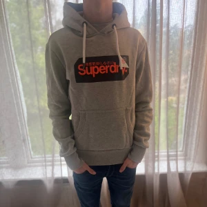 Superdry Hoodie - Superdry hoddie i storlek s. Färgen är Grå. Hoddie är i mycket bra skick 9/10. Modellen är 177cm och väger 65kg📏 skriv för mer info✅