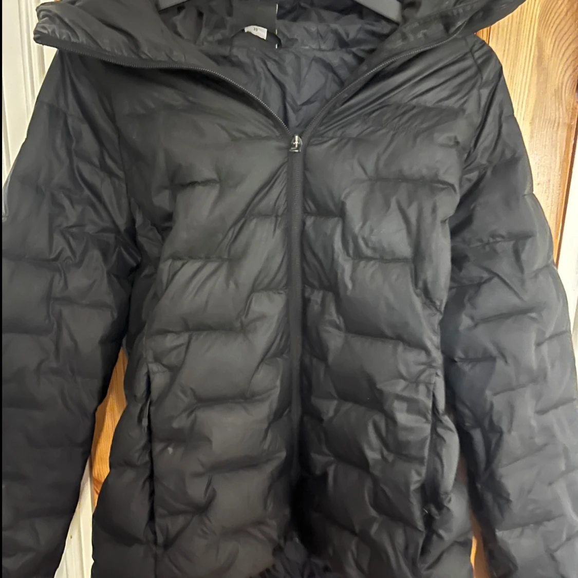 Svart pufferjacka med huva