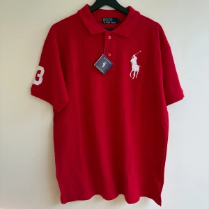 Röd Polo Ralph Lauren pikétröja - Polo Ralph Lauren piké i storlek L. Den är helt ny, aldrig använd och har lappen kvar, ny pris 1149kr. Pris kan diskuteras, tveka inte på att höra av dig vid minsta fundering😁