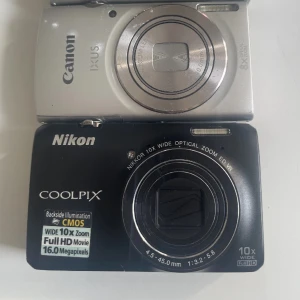 Canon IXUS 175 & Nikon Coolpix S6300 kompaktkameror - Två smidiga digitalkameror: Canon IXUS 175 med 8x optisk zoom och Nikon Coolpix S6300 med 10x optisk zoom, 16 MP och Full HD-video. Båda i gott skick med mindre ytliga repor, perfekta för resor eller vardagsfotografering. Skriv för pris!