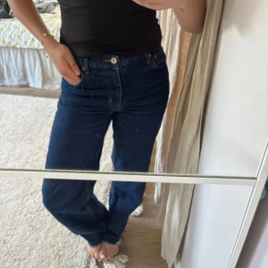 Mörkblå raka jeans  - Mörkblå jeans  med klassisk rak passform och normal midja. Jeansen har fem fickor, knappgylf och är tillverkade i robust denim. Perfekta för en avslappnad och stilren look. Midwaist