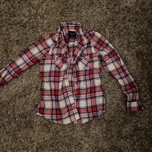 Rutig skjorta  - Fet rutig skjorta från American eagel. Skjortan har inga tecken på använding. Skjortan är i storlek S. Skjortan passar bra till allt men är perfekt nu till vintern man kan ha den under jackor tröjor vad som allt blir skit snygg. Skjortan kommer säljas för 300 kr 