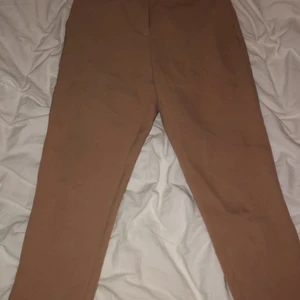Kostymbyxor från NAKD - Säljer mina beiga kostymbyxor ifrån NAKD. Storlek 36 men passar en XS/S beroende på hur man vill att de ska sitta🥰