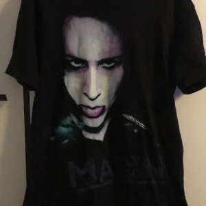 marilyn manson tröjor - två marilyn manson t-shirts, den svarta (L 150kr) är i väldigt fint skick typ nyskick då jag knappt använt den. den vita (M 50kr) har några fläckar och är lite missfärgad men annars inga andra defekter. pris diskuterbart och köper du båda blir det billigare