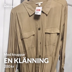 En brun beige klänning  - Den passar även för gravida. Den har storleken XXL. Den är oanvänd och kostar 200kr