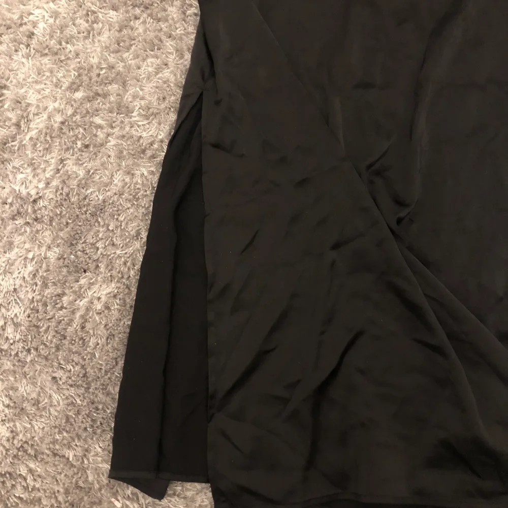 Lång svart silkes klänning med en lång slits längst ner vilket gör klänningen extra fin. Endast använd en gång. Ny pris 299kr. Från H&M. 💕💕. Klänningar.