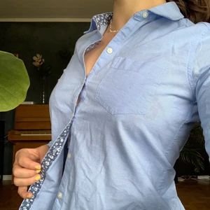 LjusBlå skjorta - Ljusblå skjorta med Blom-detaljer från Hollister. Storlek xs. Köpare står för frakt!