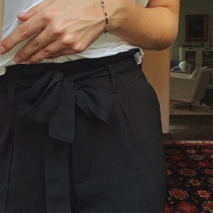 Svarta kostymbyxor strl. XS - Svarta skira kostymbyxor som knyts i midjan ifrån Bikbok. Älskar dem men säljer pga att de blivit för korta för mig. Är i mycket gott skick!🥰