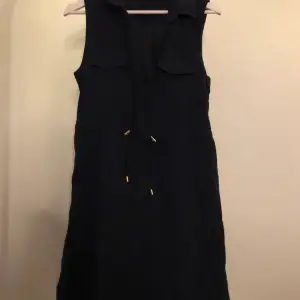 En svart/blå klänning från hm som går att spänna åt i midjan i stl 38