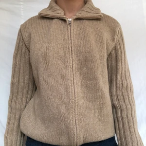 Kofta - Mysig beige stickad kofta med nervikt polokrage. Visas på en storlek s men passar upp till L beroende på önskad passform! Köparen står för frakten