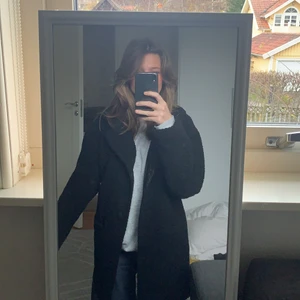 Teddykappa - Svart teddykappa, går till mitten av låren, varm