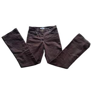 Ett par bruna jeans i storlek 34 (dam). Byxorna är vintage H&M och har synliga sömmar i en ljus beige färg. Byxorna är gjorda i ett tunnare jeans tyg och är i bra skick. (70% Bomull 27% Polyester 3% Elastan)