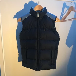 Nike Väst - Nike puffer väst i storlek small. Reflex remsor vid axlarna och Nike märke på ryggen och vänstra bröst. Varm