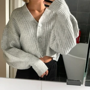 Stickad Grå Kofta  - Grå kofta från gina tricot. Knappt använd. En knapp har lossnat men den sydda jag dit igen. Original pris tror jag är 250kr. Säljer för 100+frakt 