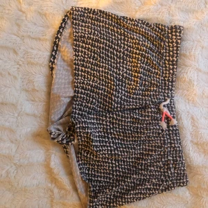 Shorts från H&M  - Svart/rosa shorts från H&M, lite oklart vad det är för mönster men men. Strl 158/164