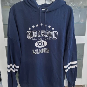 Marinblå hoodie med tryck - En marinblå hoodie med tryck i oversize passform i storlek S från H&M DIVIDED men är köpt secondhand och är använd några gånger men fortfarande i bra/fint skick! Finns inga synliga tecken på användning vad jag kan se. FÖRST TILL KVARN!