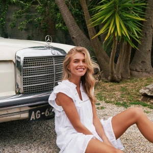  Ny volangklänning från Neo Noir, still 34 - Supersöt vit kortklänning från Neo Noir med volangärmar, v-ringning och broderade detaljer. Klänningen är luftig och har en avslappnad passform med flera lager och spetsinslag. Perfekt för varma dagar och ger en fräsch sommarkänsla.