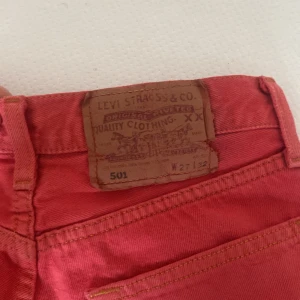 jeansshorts från Levi's - Snygga röda jeansshorts från Levi's modell 501. De har en klassisk femficksdesign och fransiga kanter för en avslappnad look. Perfekta för sommardagar! Kan diskutera pris.