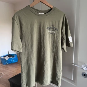T-shirt Gracious - T-shirt med Gracious märke med ett fett tryck på ryggen, denna T-shirt är riktigt fet enligt mig och jag erbjuder ett väldigt rimligt pris för den.