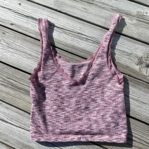 Rosa croppad linnetopp med volangkant - Säljer en söt rosa croppad linnetopp med volangkant längs axelbanden och v-ringning. Perfekt för varma dagar och enkel att matcha med jeans eller kjol.