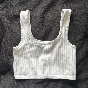 Ribbad tanktop - En vit ribbad tanktop som är sval. Bredare band och ett stretchiga material men sitter ändå bra. Köpt på NewYorker i storlek S/M. Skriv vid frågor 🌸🫶🏻