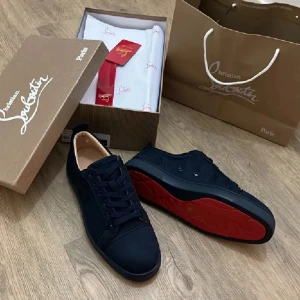 Svarta sneakers från Christian Louboutin - Säljer ett par svarta sneakers från Christian Louboutin med klassisk röd sula. Skorna har rund tå, snörning och är tillverkade i skinn. Perfekta för dig som vill ha en stilren och lyxig look.