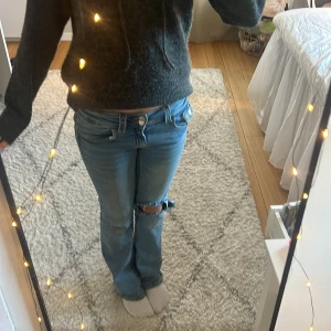 Ljusblå jeans från Gina Tricot - Säljer ett par ljusblå jeans från Gina men eget gjort hål.