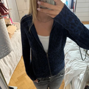 Mörkblå Zadig leopardmönstrad zip-up tröja - Mörkblå stickad zip-up med coolt leopardmönster och dragkedja. 100% kashmir och jätteskön. Går att ha som tex myströja men också klä upp den och bära som tröja till vardags.