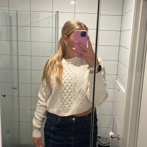 Vit croppad stickad tröja Gina Tricot - Säljer en vit croppad stickad tröja från Gina Tricot med snyggt flätmönster och ribbade muddar. Tröjan är fåtal använd men jätte skön och fint skick!