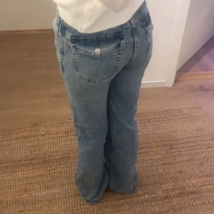 Blåa bootcut - Säljer ett par klassiska blå jeans med bootcut  och snygga fina detaljer där bak bak. Har typ aldrig kommit till användning 💗