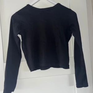 Svart långärmad  - Säljer en stilren svart långärmad. Perfekt för en trendig look. Passar bra till både jeans och kjol.